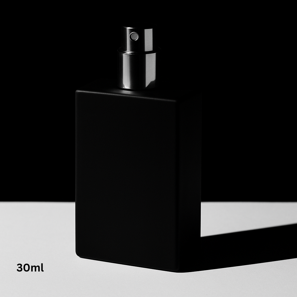 Black spray bottle with silver nozzle on a black and white background